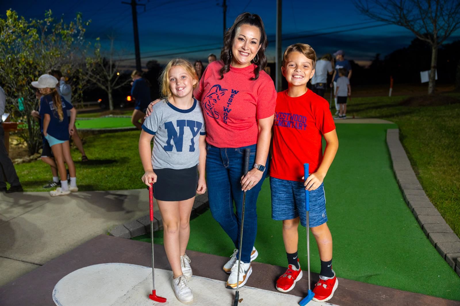 principal and two students at mini golf